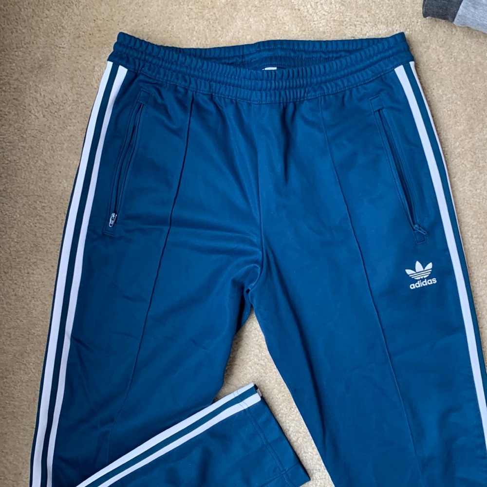 Adidas marine-blue colored track pants.